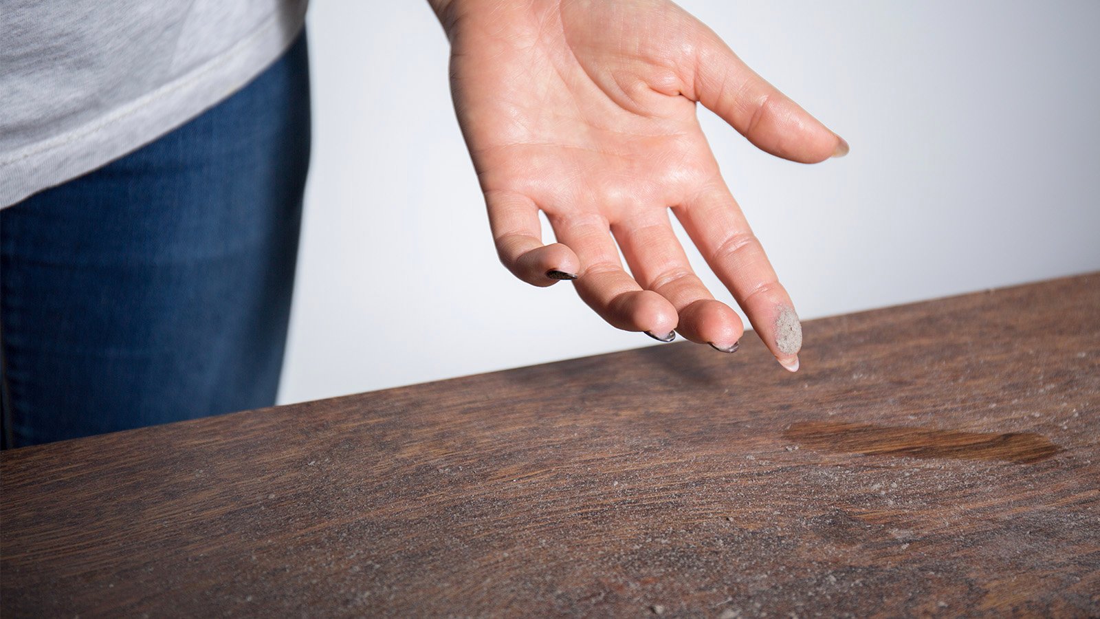 Close-up of dust on woman finger