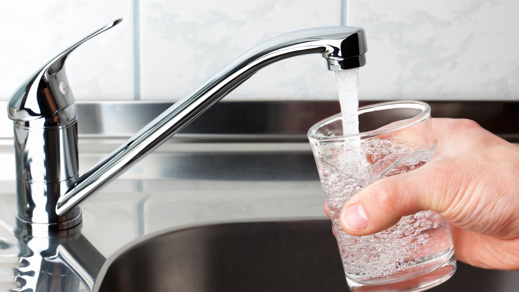 Glass filled with drinking water from kitchen faucet.