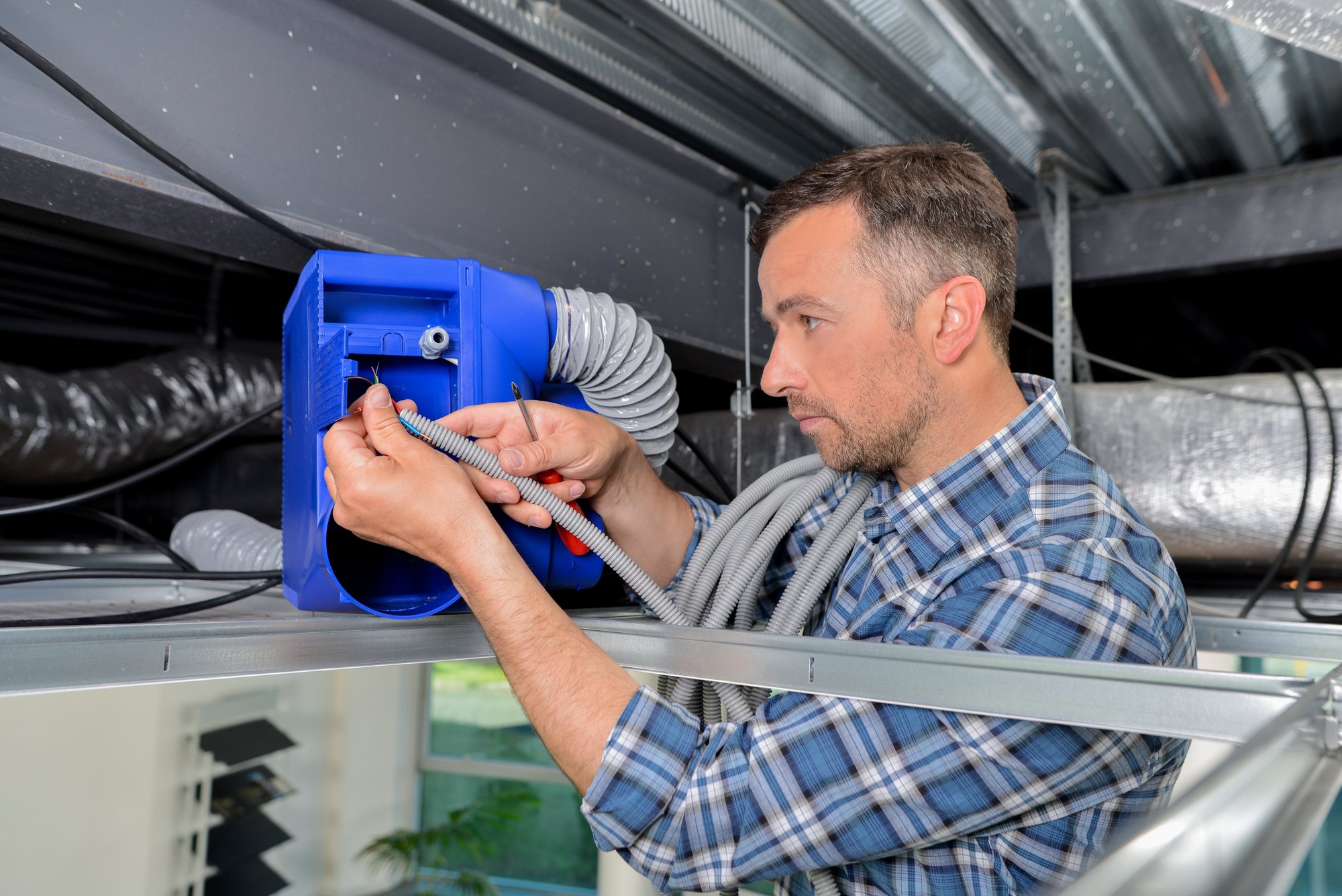 Man repairing ventilation system