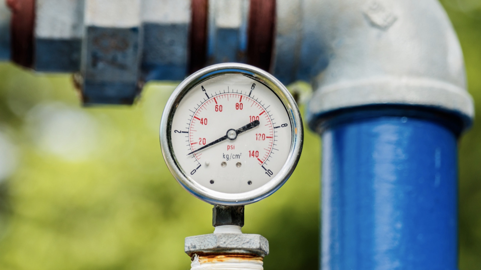 Water pressure meter installed on a blue pipe