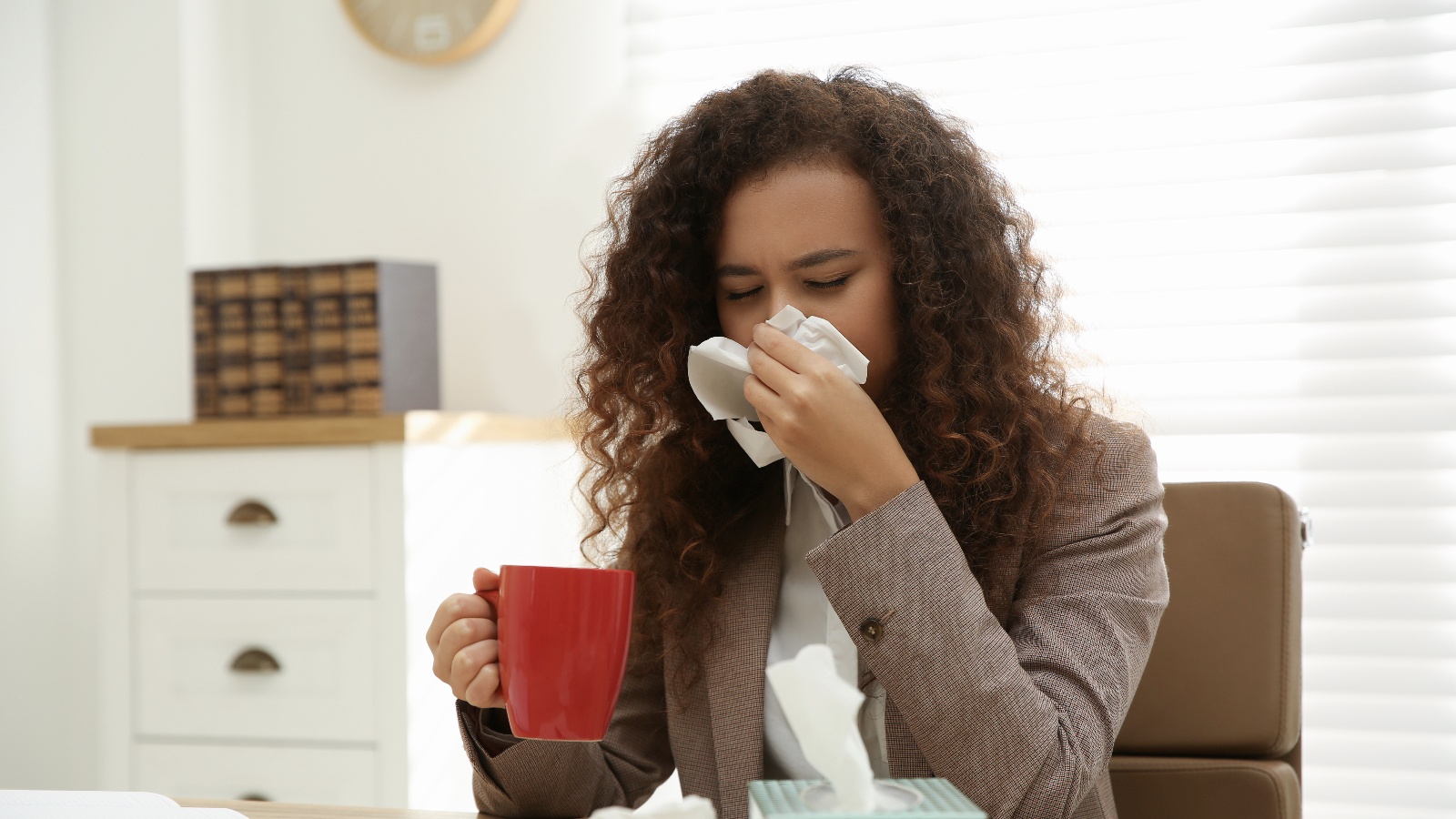 Woman sneezing due to spring allergies