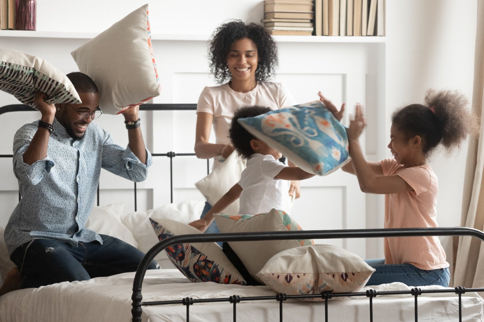 Family having a pillow fight with kids in their home-1